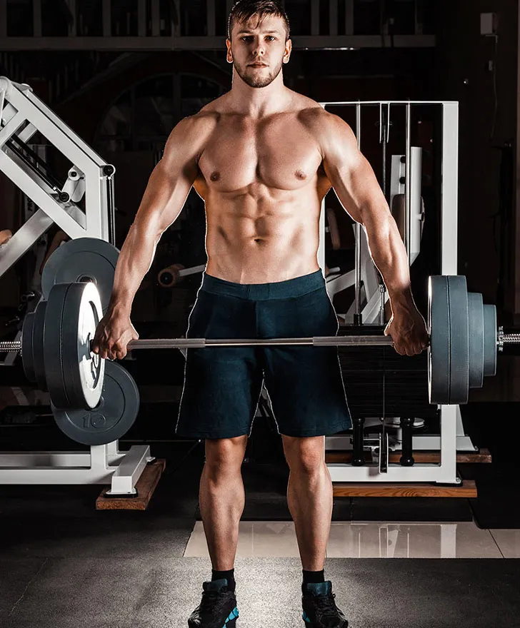 Athlete lifting a loaded barbell in a strength training gym